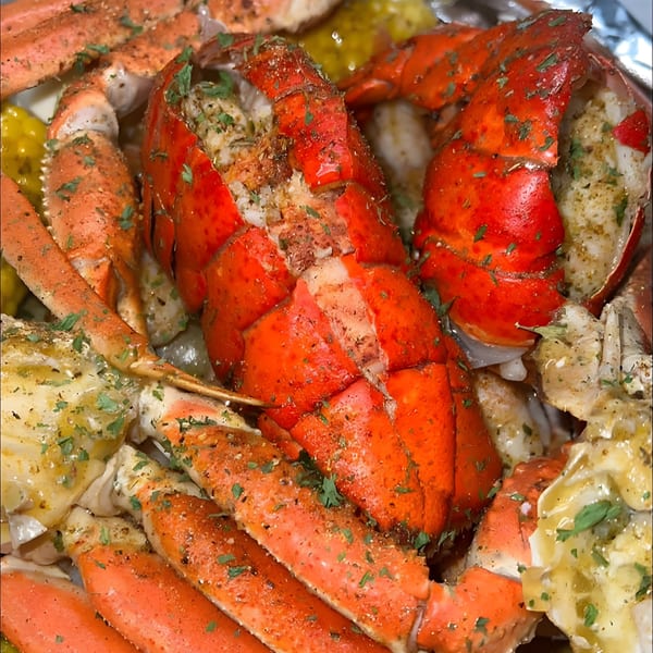 Royal Krabz seafood boil with bright red lobster tails, crab legs, and corn on the cob.