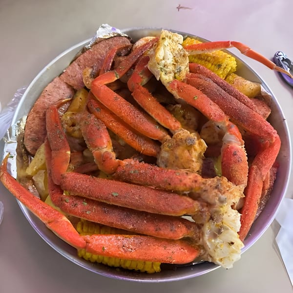 A Royal Krabz seafood boil with snow crab legs, sausage, potatoes, and corn on the cob.