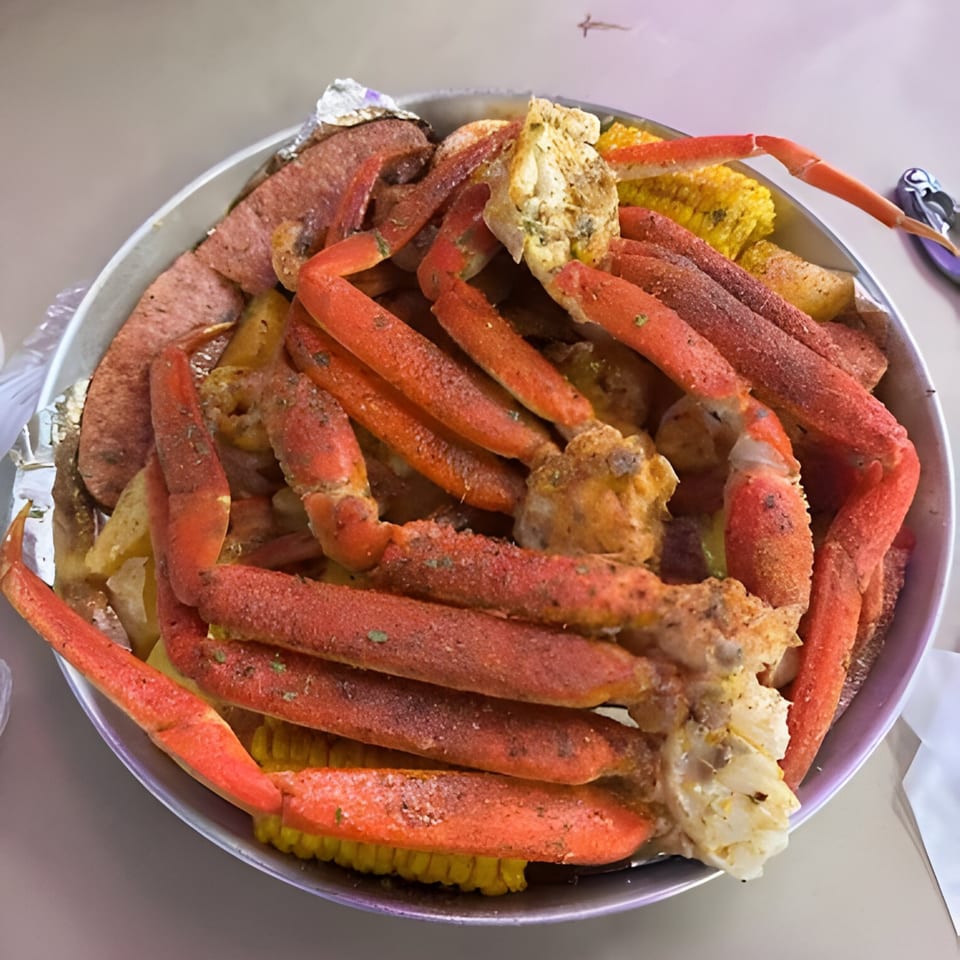 A Royal Krabz seafood boil with snow crab legs, sausage, potatoes, and corn on the cob.